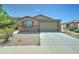 Charming single-story home featuring a two-car garage and low maintenance desert landscaping with stone accents at 25755 W Hazel Dr, Buckeye, AZ 85326