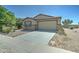 Charming single-story home featuring a two-car garage and low maintenance desert landscaping with stone accents at 25755 W Hazel Dr, Buckeye, AZ 85326