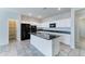 Spacious kitchen with white cabinets, granite countertops, stainless steel appliances, and a large center island at 25755 W Hazel Dr, Buckeye, AZ 85326