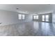 Bright and airy living room featuring tile floors, multiple windows, and a glass doors providing access to the backyard at 25755 W Hazel Dr, Buckeye, AZ 85326