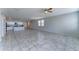 Large open living space combines living and dining, featuring tile flooring and a ceiling fan at 25755 W Hazel Dr, Buckeye, AZ 85326