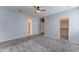 Spacious carpeted main bedroom featuring ceiling fan and access to en suite bathroom and walk-in closet at 25755 W Hazel Dr, Buckeye, AZ 85326