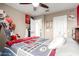 Bedroom with Cardinals-themed decorations, fan, carpeted floor, and a well-lit interior at 2605 W Golden Puma Trl, Phoenix, AZ 85085