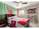 Fun bedroom with a bed, fan, bookshelves, and Cardinals themed decor, perfect for a young sports fan at 2605 W Golden Puma Trl, Phoenix, AZ 85085