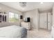 Neutrally decorated bedroom with a large window, light fixtures, a ceiling fan, and plush carpet at 2605 W Golden Puma Trl, Phoenix, AZ 85085