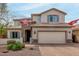 Charming two-story home with a manicured lawn and attached two-car garage at 2605 W Golden Puma Trl, Phoenix, AZ 85085