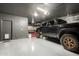 Finished garage showcasing an epoxy floor, black walls and ceiling, lighting, and ample space at 2605 W Golden Puma Trl, Phoenix, AZ 85085