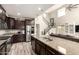 Modern kitchen features stainless steel appliances, granite countertops, dark cabinets, and an island with a double sink at 2605 W Golden Puma Trl, Phoenix, AZ 85085