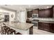 Modern kitchen with granite countertops, stainless steel appliances, and a stylish breakfast bar at 2605 W Golden Puma Trl, Phoenix, AZ 85085