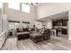 Spacious living room with high ceilings, large windows, and seamless connection to the kitchen at 2605 W Golden Puma Trl, Phoenix, AZ 85085