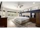 Luxurious main bedroom features a tufted headboard, accent wall, neutral decor, and lots of natural light at 2605 W Golden Puma Trl, Phoenix, AZ 85085