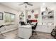Bright home office with built-in shelving, a spacious desk, and a large window view at 2605 W Golden Puma Trl, Phoenix, AZ 85085