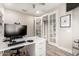 Well-lit home office with ample desk space, storage, and stylish French doors at 2605 W Golden Puma Trl, Phoenix, AZ 85085