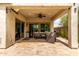 Covered patio area with a ceiling fan, tiled floor, and comfortable seating for outdoor relaxation at 2605 W Golden Puma Trl, Phoenix, AZ 85085