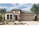 Charming single-story home with stone accents, neutral stucco, a two-car garage, and low maintenance landscaping at 26079 S 228Th St, Queen Creek, AZ 85142