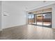 An open living space with wood-look tile flooring and large sliding glass doors overlooking the backyard at 26079 S 228Th St, Queen Creek, AZ 85142