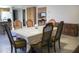 This dining area features a table with ornate chairs, and there is a view into the kitchen at 2738 E Libby St, Phoenix, AZ 85032