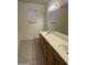 Bathroom featuring double sinks, oak cabinetry, a large mirror and tile flooring at 3330 S Gilbert Rd # 1003, Chandler, AZ 85286