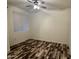 This bedroom features vinyl floors, a ceiling fan, and natural light from a window at 3330 S Gilbert Rd # 1003, Chandler, AZ 85286