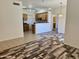 Open-concept living space with mixed flooring, seamlessly connecting the kitchen and living areas for easy socializing at 3330 S Gilbert Rd # 1003, Chandler, AZ 85286