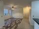 Spacious living area with mixed flooring, ceiling fan, and a bright entryway provides a welcoming space for entertaining at 3330 S Gilbert Rd # 1003, Chandler, AZ 85286