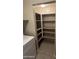 Pantry with shelving is next to the laundry machines at 3330 S Gilbert Rd # 1003, Chandler, AZ 85286