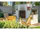 Inviting backyard with an outdoor fireplace, comfortable seating, and lush greenery for relaxation at 3921 W Sheffield Ave, Chandler, AZ 85226