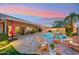 Inviting backyard oasis with a sparkling pool, covered patio, and cozy seating area at 3921 W Sheffield Ave, Chandler, AZ 85226