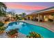 Stunning backyard with a pool, covered patio, and lush landscaping, perfect for outdoor living at 3921 W Sheffield Ave, Chandler, AZ 85226