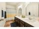 Bathroom featuring double sinks with a white countertop, dark cabinets, and a shower with a curtain at 3921 W Sheffield Ave, Chandler, AZ 85226