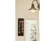 Modern hallway featuring an industrial-style light fixture and wall art at 3921 W Sheffield Ave, Chandler, AZ 85226