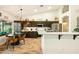 Charming kitchen featuring dark cabinets, white countertops, and an adjacent dining area perfect for casual meals at 3921 W Sheffield Ave, Chandler, AZ 85226