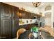 Kitchen with dark wood cabinets, stainless steel appliances, white countertops, and eat-in breakfast table at 3921 W Sheffield Ave, Chandler, AZ 85226