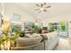 Inviting living room with cozy seating, natural light, and sliding glass doors opening to a private outdoor pool area at 3921 W Sheffield Ave, Chandler, AZ 85226