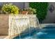 Beautiful pool with stone waterfall feature, perfect for relaxation and outdoor enjoyment at 3921 W Sheffield Ave, Chandler, AZ 85226