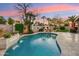 Inviting pool area with a stone waterfall and an outdoor fireplace, perfect for entertaining at 3921 W Sheffield Ave, Chandler, AZ 85226