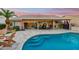 Beautiful pool with seamless patio, covered seating, and lush landscaping at 3921 W Sheffield Ave, Chandler, AZ 85226