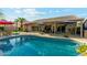 Sparkling swimming pool with inviting lounge area, umbrellas, and manicured landscaping for outdoor enjoyment and relaxation at 3921 W Sheffield Ave, Chandler, AZ 85226