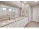 Bathroom featuring dual vanities, neutral countertop, modern mirrors, and a spacious glass shower at 4119 S 176Th Dr, Goodyear, AZ 85338