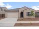 Charming single-story home with a two-car garage, desert landscaping, and a welcoming front entrance at 4119 S 176Th Dr, Goodyear, AZ 85338