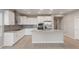 Bright and modern kitchen featuring white cabinets, stainless steel appliances, and a spacious island at 4119 S 176Th Dr, Goodyear, AZ 85338