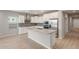 Bright and modern kitchen featuring white cabinets, stainless steel appliances, and a large island with sink at 4119 S 176Th Dr, Goodyear, AZ 85338