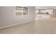 Bright, open-concept living area with tile floors and a view into the modern, white kitchen at 4119 S 176Th Dr, Goodyear, AZ 85338