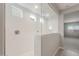Bright bathroom with a glass-enclosed shower showcasing white tile and multiple shower heads at 4119 S 176Th Dr, Goodyear, AZ 85338