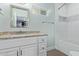 Bright bathroom showcasing a granite countertop vanity and white tiled shower/tub combo at 4208 E Windsor Ave, Phoenix, AZ 85008