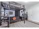 Bedroom featuring a lofted bed, sofa, desk, and a geometric accent wall at 4208 E Windsor Ave, Phoenix, AZ 85008