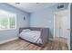 Cozy bedroom with a daybed under a window providing natural light, featuring wood-look flooring at 4208 E Windsor Ave, Phoenix, AZ 85008
