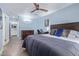 Relaxing bedroom with a ceiling fan, desk space, and a view into the ensuite bathroom at 4208 E Windsor Ave, Phoenix, AZ 85008