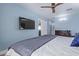 Bright bedroom features a ceiling fan, neutral walls, and a TV, creating a comfortable and inviting space at 4208 E Windsor Ave, Phoenix, AZ 85008