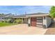 Attractive house with a long driveway, modern garage door, and well-kept landscaping at 4208 E Windsor Ave, Phoenix, AZ 85008